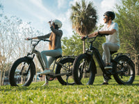 Rider using a black Velowave Ranger Step-Thru 2.0 on a paved urban path