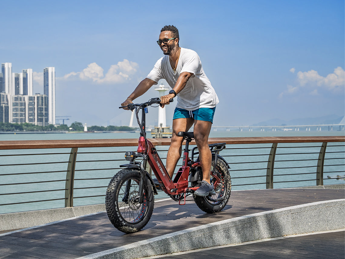 Heybike Ranger 3.0 Pro folding fat-tire electric bike with 750W rated rear-hub motor, KENDA 20 by 4 inch fat tires with puncture protection, hydraulic disc brakes, Shimano Altus 8-speed gearing, hydroformed aluminum folding frame, hydraulic front suspension, TFT color display, NFC Tap & Go unlocking, integrated turn signals, available in Ruby Red, Sapphire Blue, or Emerald Green