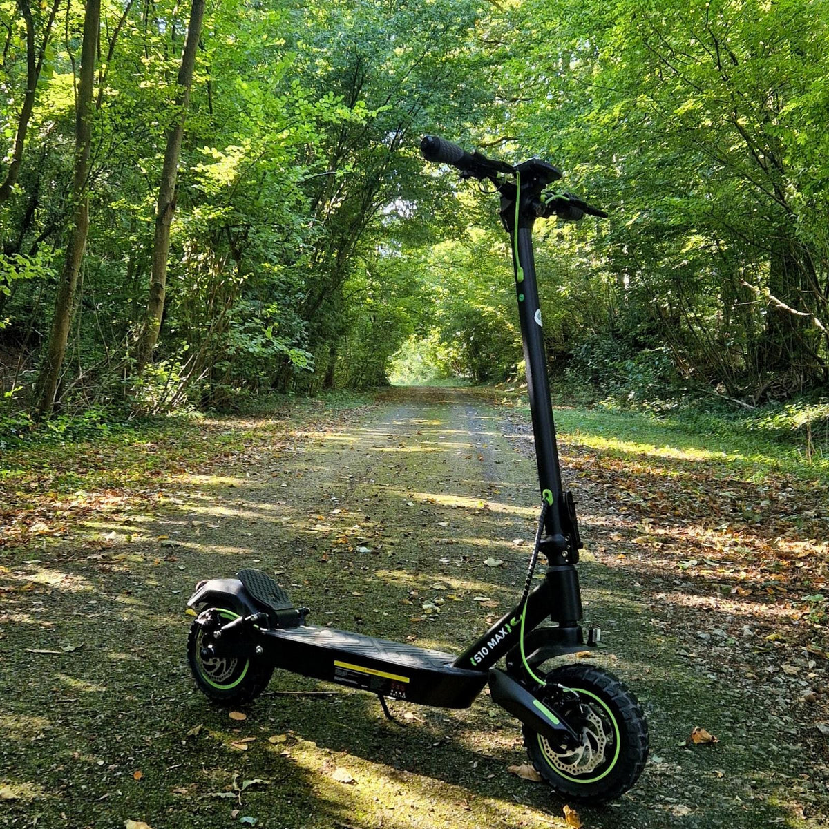 isinwheel S10Max parked on a shaded paved path through green woodland