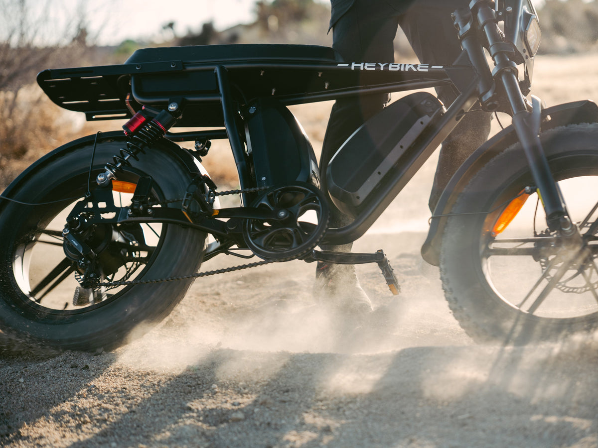 Heybike Saturn moped-style commuter e-bike: 52V 1000W continuous / 1800W peak hub motor, 95 Nm torque, single or dual-battery configuration, hydraulic disc brakes, full suspension with 140 mm front travel, turn signals, TFT color display, UL 2849 certified