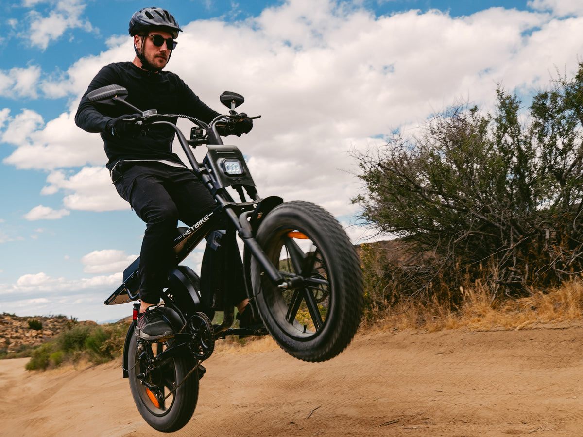 Heybike Saturn moped-style commuter e-bike: 52V 1000W continuous / 1800W peak hub motor, 95 Nm torque, single or dual-battery configuration, hydraulic disc brakes, full suspension with 140 mm front travel, turn signals, TFT color display, UL 2849 certified