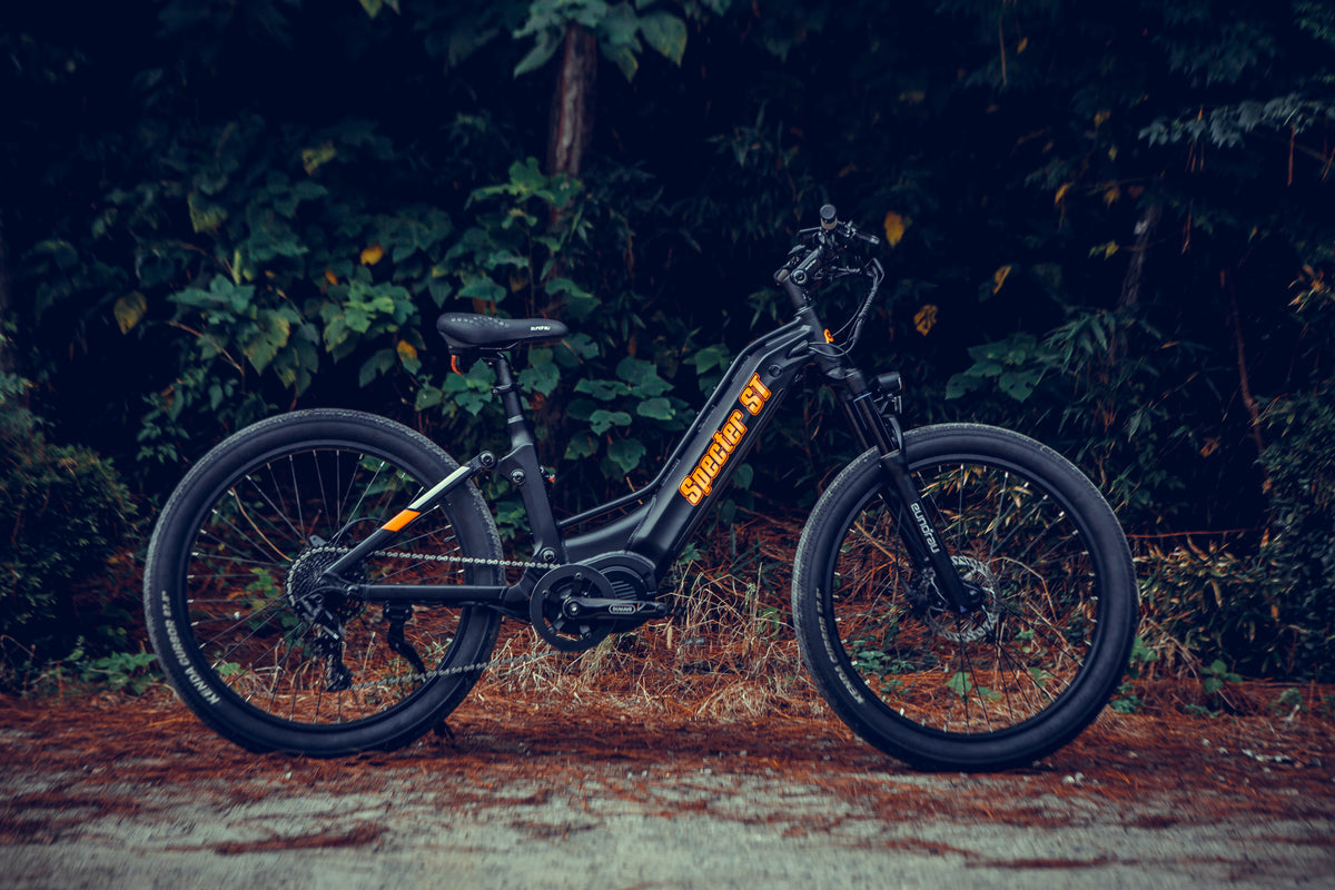Black EUNORAU SPECTER-ST 2.0 full-suspension e-bike beside a wooded trail