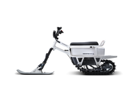 White Moonbike side view showing the compact snow-bike profile.