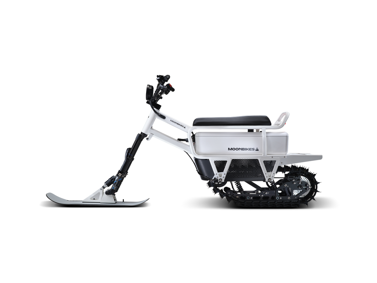 White Moonbike side view showing the compact snow-bike profile.