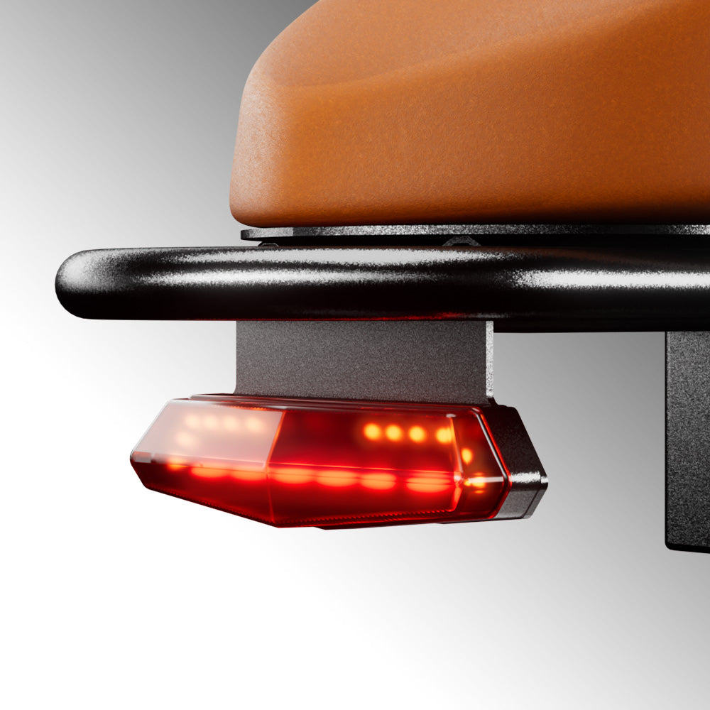 Rear brake light glowing beneath the Run Mini saddle
