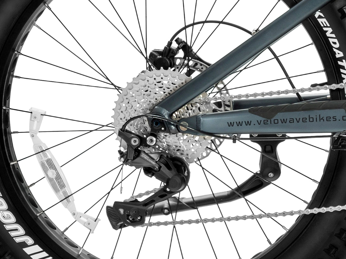 Dark Blue Brawny XM battery pack shown removed from the frame beside the front fork