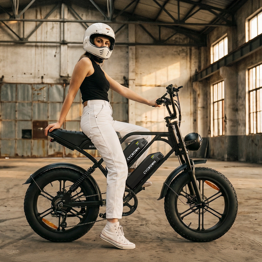 Rider in a white helmet standing over the CycHunter 2.0 indoors
