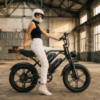 Rider in a white helmet standing over the CycHunter 2.0 indoors