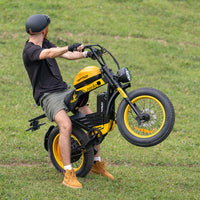 Side profile of the black HappyRun G100 Pro Tank on a paved private road, showing the moto-cruiser stance and long bench saddle