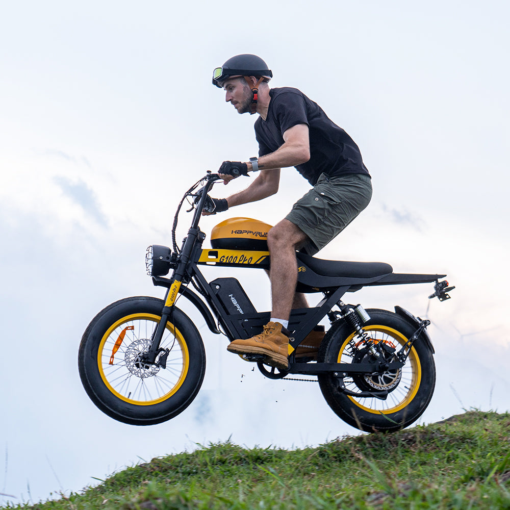 Side studio view of the black HappyRun G100 Pro Tank with the moped-style tank shell, long bench saddle, and 20 by 4 inch road tires