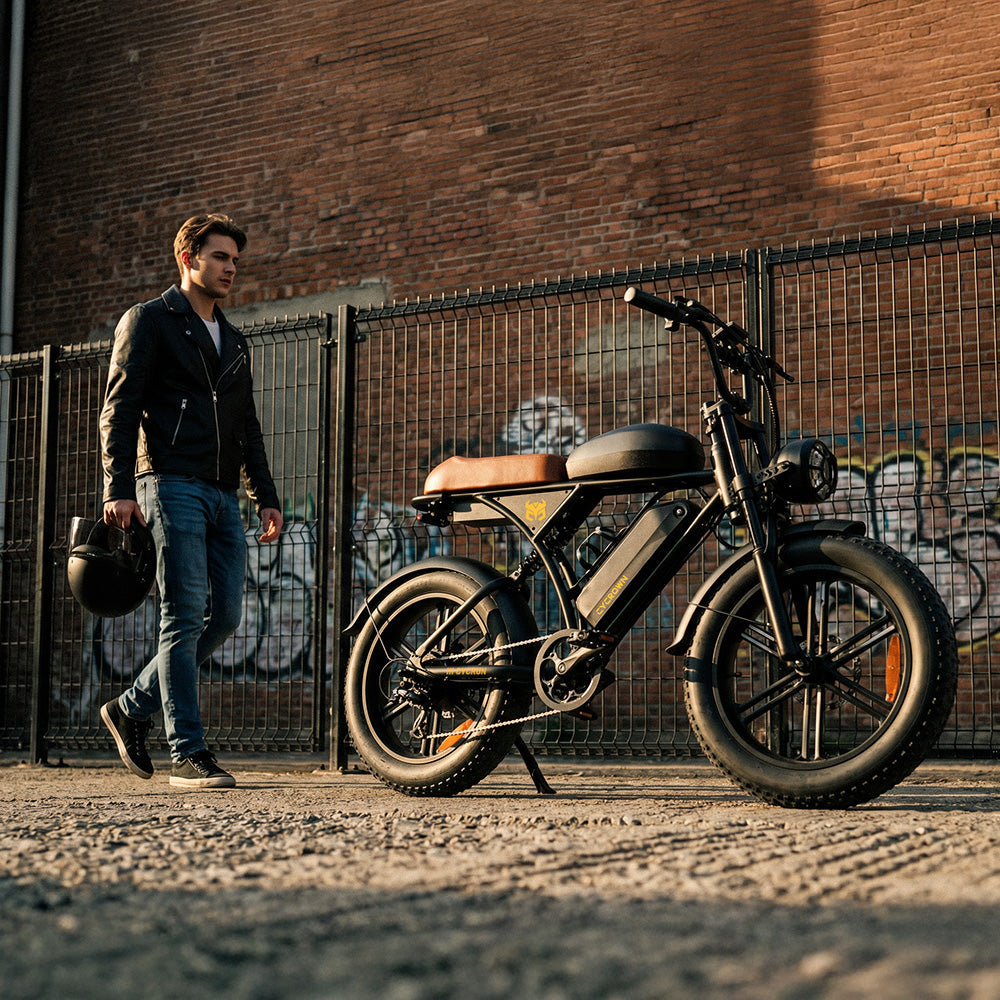 Man standing beside a CycRun 2.0 on an urban cobblestone street