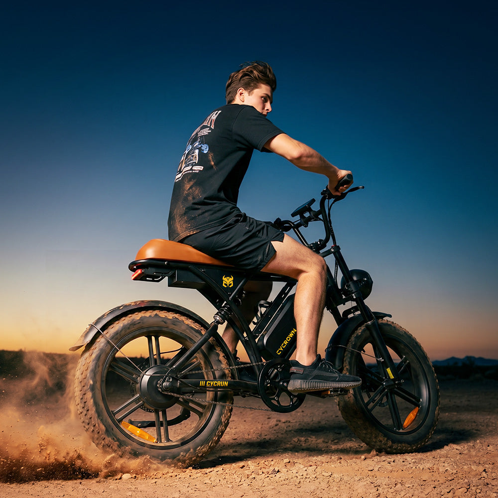Rider accelerating the CycRun 2.0 across a dusty trail at sunset