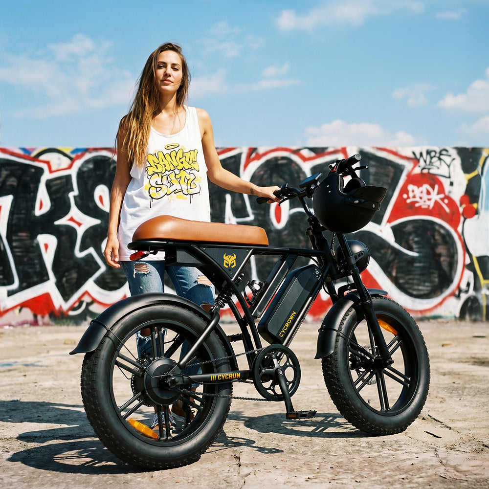 Woman standing beside a CycRun 2.0 in front of a graffiti wall